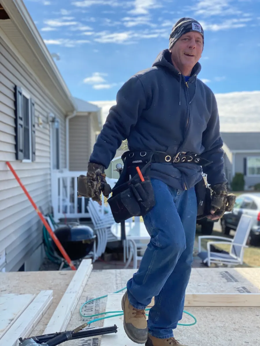 Carpenter on a job site, framing a new floor deck
