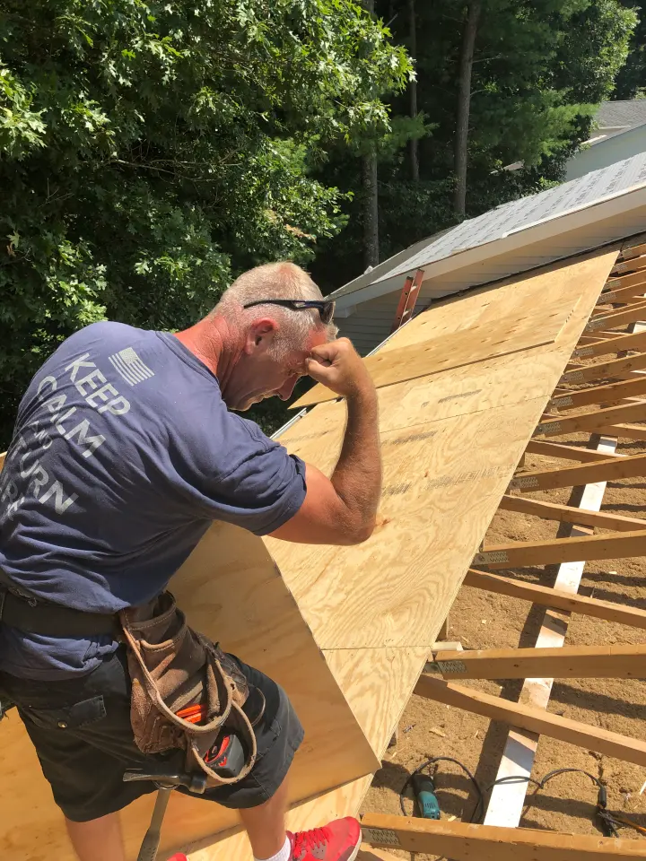 Laying roof sheathing over new rafters